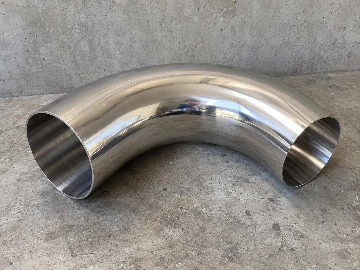 Buffed stainless elbow — representative component illustration
