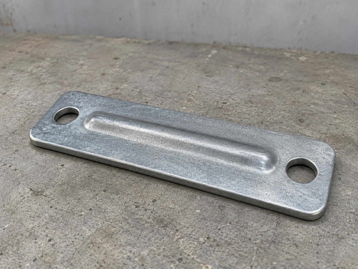 Zinc-nickel clamp cover plate — representative component illustration